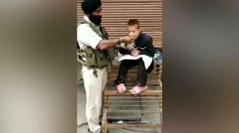 Crpf jawan and kashmiri child Crpf jawan and kashmiri child
