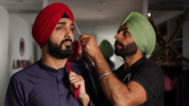 Jagdeep Singh Grewal, right, owns a turban-tying company Jagdeep Singh Grewal, right, owns a turban-tying company