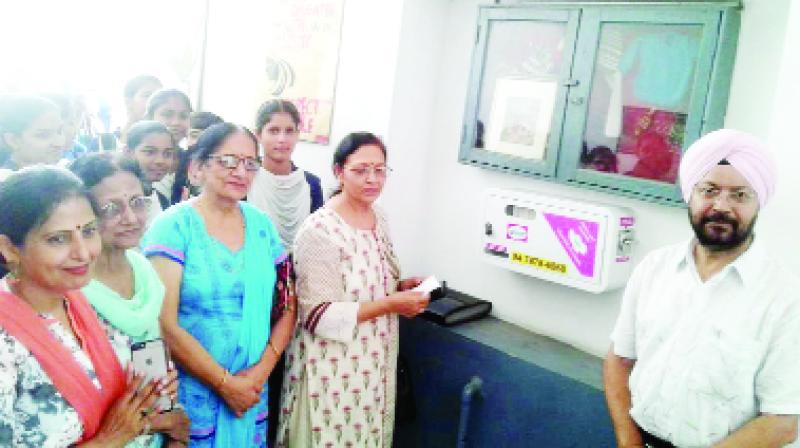 Social worker Shashi Datta with sanitary machine given to school. Social worker Shashi Datta with sanitary machine given to school.
