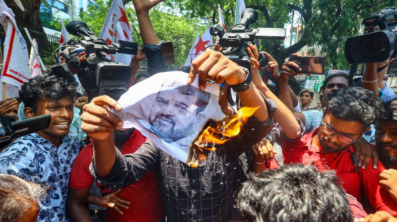 Chennai: Members of AIDWA, DYFI and SFI burn a poster of BJP MP Brij Bhushan Sharan Singh as they demand his arrest during a protest in solidarity with the protesting wrestlers, in Chennai, Friday, June 2, 2023