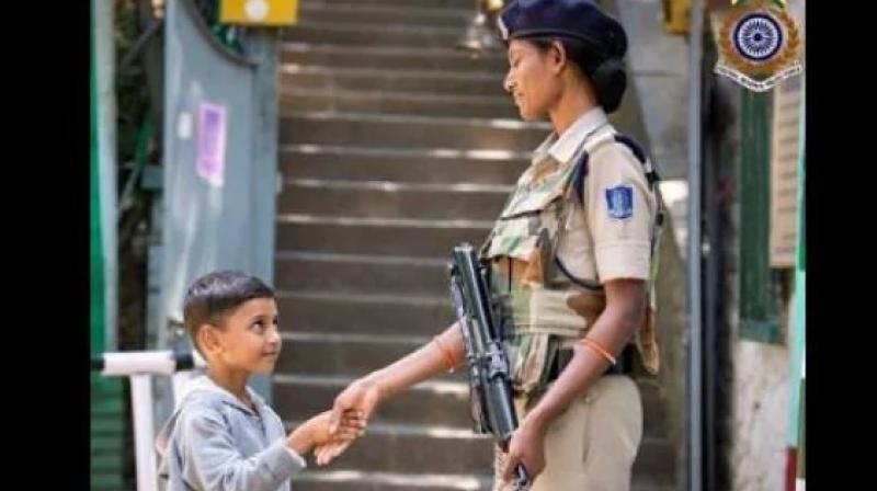 CRPF female employee shakes hands with child, picture goes viral CRPF female employee shakes hands with child, picture goes viral