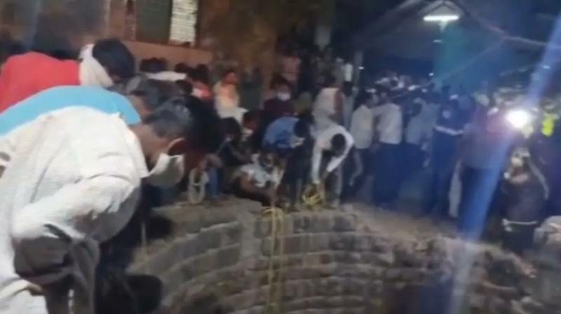 People rescuing a cat that fell into a well People rescuing a cat that fell into a well