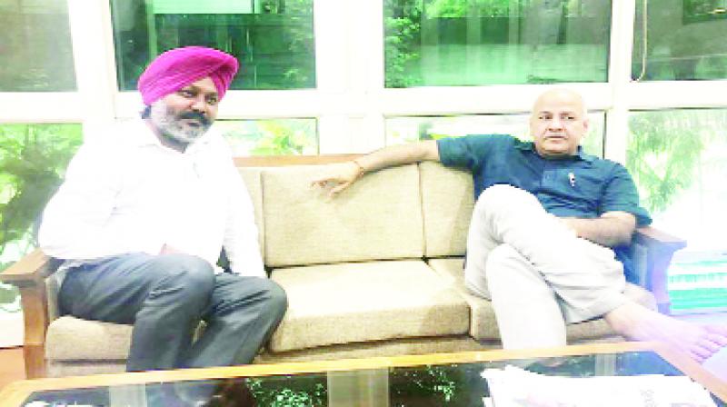 Harpal Singh Cheema with Manish Sisodia