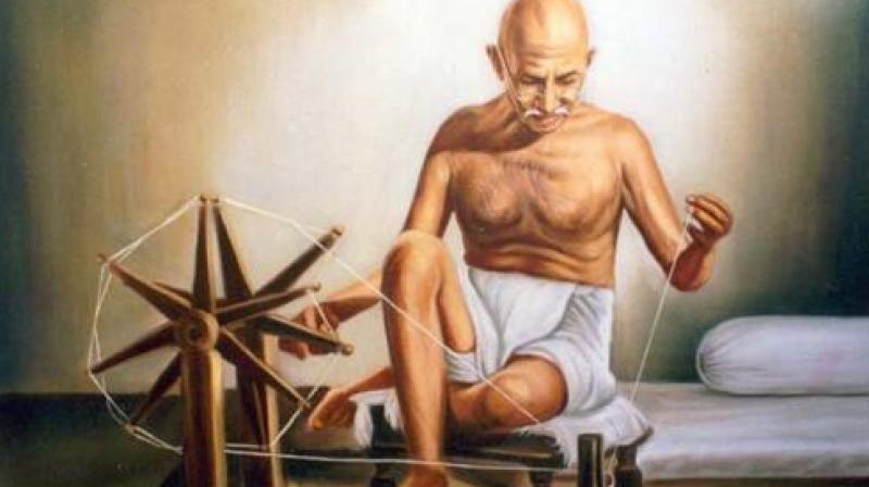 Mahatma Gandhi with his Charkha