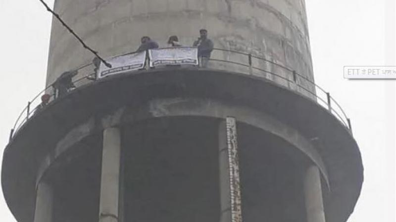 Unemployed teachers climbed on water tank