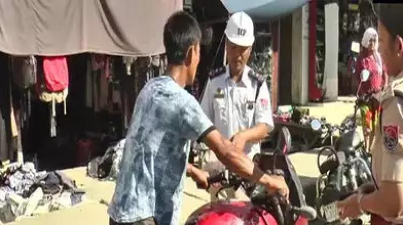 Manipur traffic police distributed toffee and sweets to helmet less bikers Manipur traffic police distributed toffee and sweets to helmet less bikers