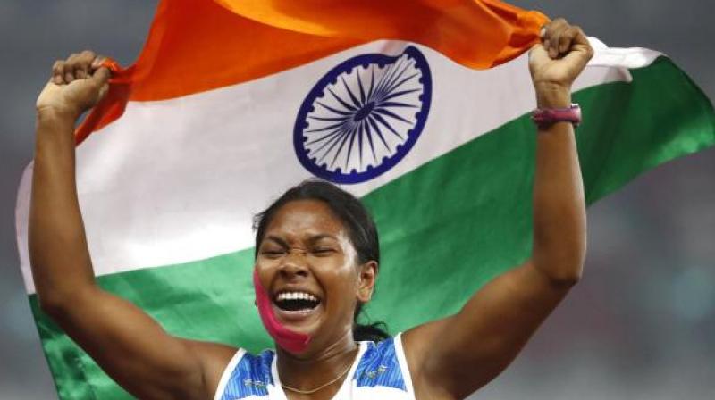 India's Swapna Barman celebrates after winning the heptathlon gold medal during the athletics competition 