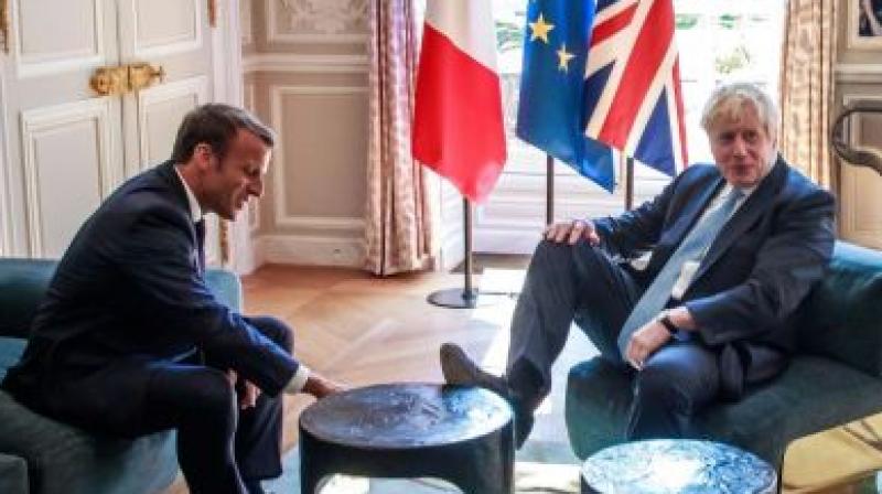 Foot on table: British PM at home in French president palace
