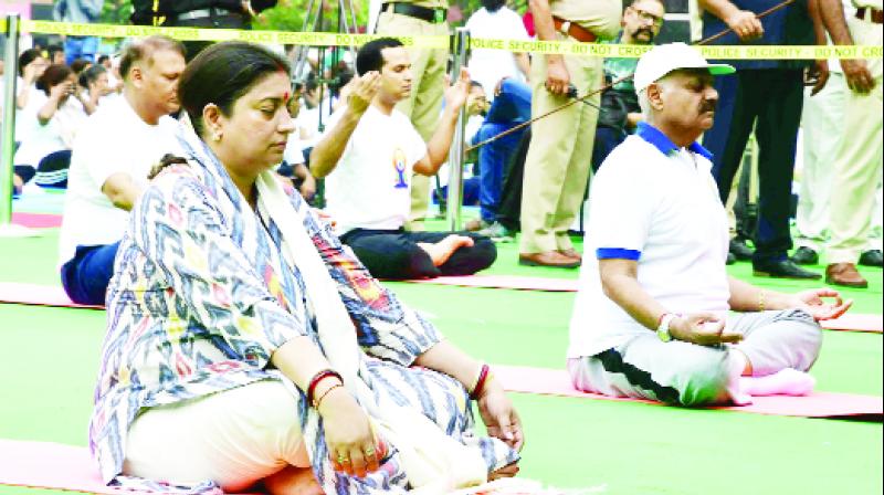 During Yoga Smriti Irani and Governor V.P. Singh Badnore