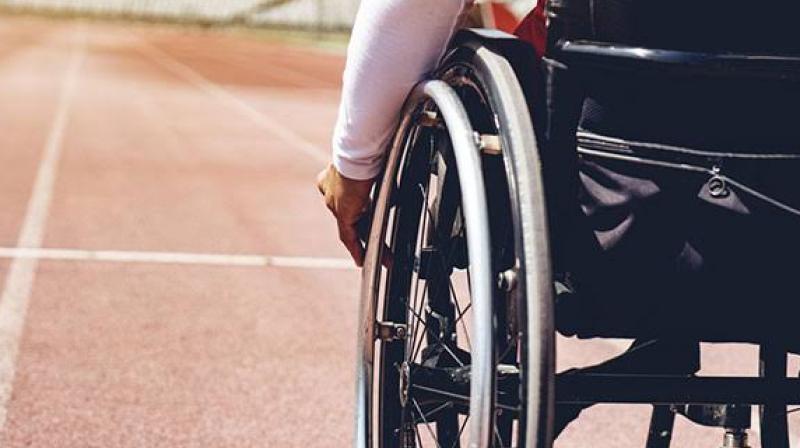 Two elderly Indian women complete a five-kilometer race in a wheelchair