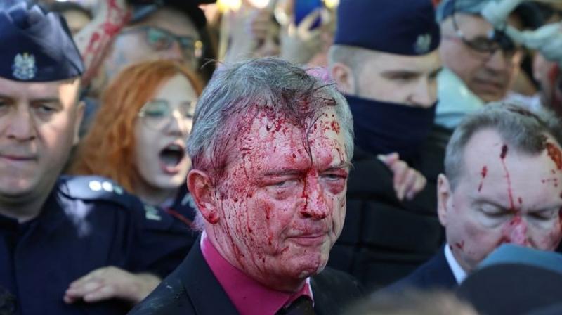 Red paint thrown at Russian envoy to Poland by anti-war protesters Red paint thrown at Russian envoy to Poland by anti-war protesters