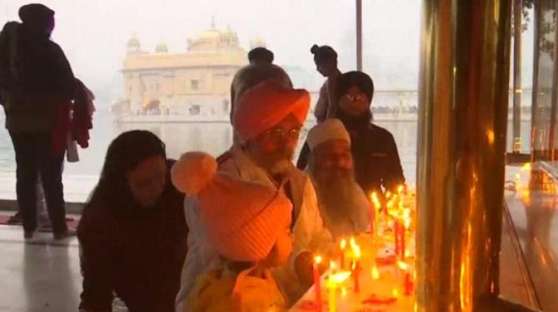 Devotees offer prayer at darbar sahib 
