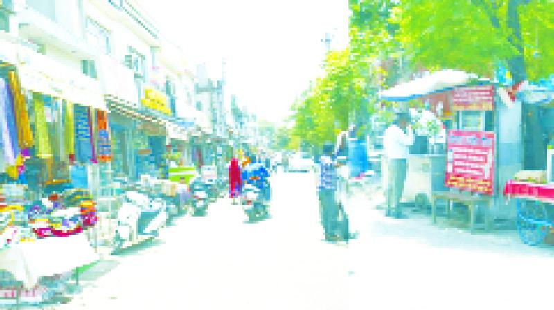  shopkeepers selling items out of their shop