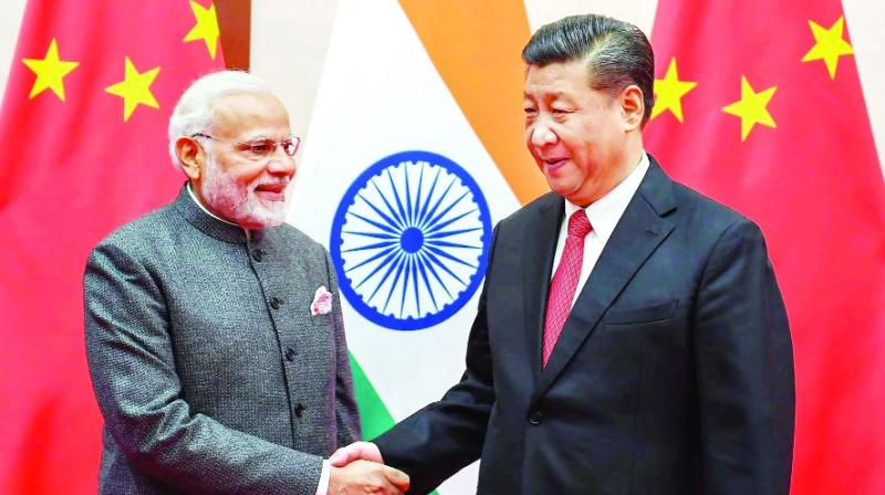 Narendra Modi shaking hands with Shi Jing Ping