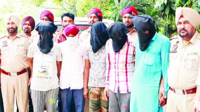 Police officers with the arrested gang Police officers with the arrested gang