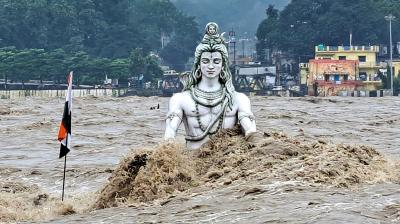 Rishikesh: An idol of Lord Shiva partially submerged in swollen Ganga river after monsoon rains, at Parmarth Niketan Ghat in Rishikesh, Monday, Aug. 14, 2023. (PTI Photo)