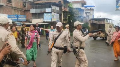 Imphal: Police try to control the situation as women stage a protest after unidentified miscreants burnt three houses, in Imphal, Sunday, Aug. 27, 2023. (PTI Photo)