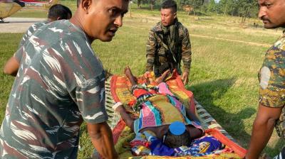 West Singhbhum: Security forces personnel carry an injured Naxalite after an exchange of fire with Maoists, in Kolhan area of West Singhbhum district. (PTI Photo)