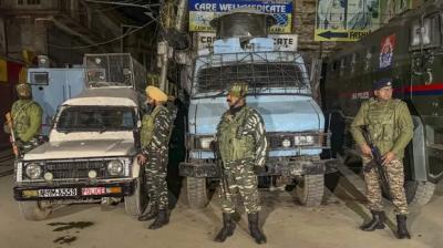 Security personnel stand guard during a cordon and search operation after terrorists shot dead a worker from Punjab while another sustained injuries in the Habba Kadal area, in Srinagar. (PTI)
