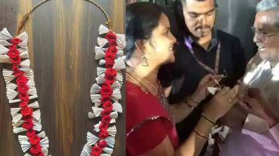 The student presented a garland made of free bus tickets to Chief Minister Siddaramaiah
