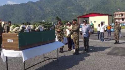 Chamoli: Army officers pay tribute to the mortal remains of soldier Narayan Singh, who went missing in the plane crash at the Rohtang Pass in 1960, at Gauchar airport in Chamoli. (PTI Photo)