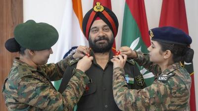 Lt. General DP Singh being pipped by his two daughters. (PTI Photo)