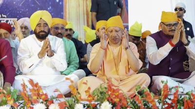 Uttar Pradesh Chief Minister Yogi Adityanath with Deputy Chief Minister Brajesh Pathak during a programme organised on the occasion of Baisakhi and Khalsa Sajna Diwas, in Lucknow. (@myogiadityanath via PTI Photo)