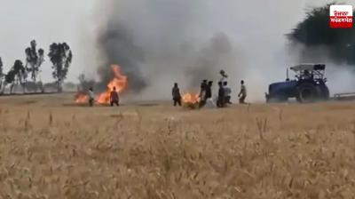 Farmer controlling fire with tractor