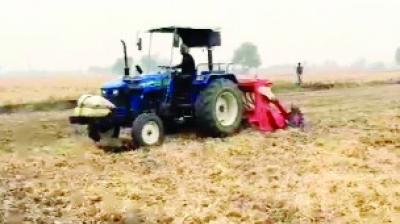 The story of Harmeet Singh, a progressive farmer plowing paddy stubble in the field