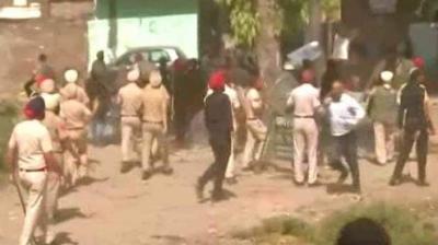 People performing at the gate, carried stones at the police