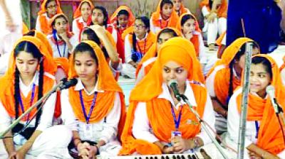 Girls are singing the words of GurBani on the occasion of Gurpurab.