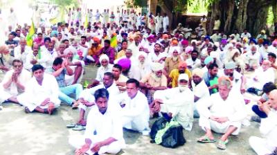 Farmers sitting on the National Highway.