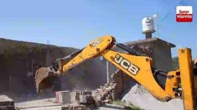 Bulldozer drives through Hazara Singh Wala slum village as part of 'War on Drugs' campaign