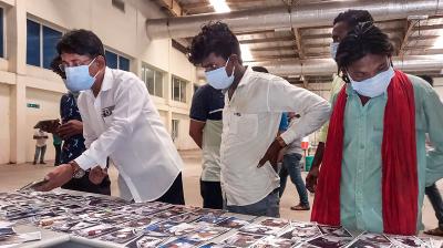 Balasore: Photos of unidentified passengers being displayed for identification by their family members following an accident involving three trains, in Balasore, Sunday, June 4, 2023. (PTI Photo)