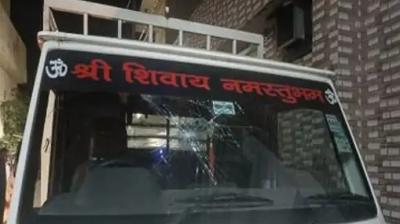 Youth vandalizing the vehicle with bricks and stones