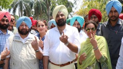Capt. Amarinder Singh and Preneet Kaur cast their votes in Patiala
