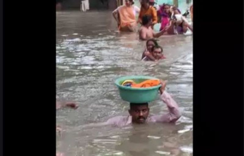 saved 2 years old child life carries tub on his head in neck deep water 