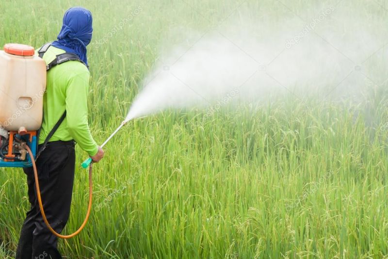 What should farmers wear while spraying?