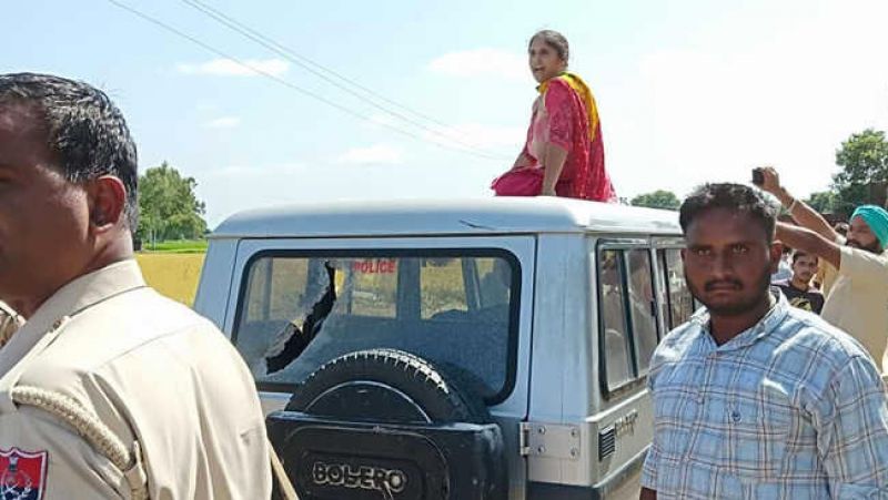 Forced Woman to sit on top of police jeep