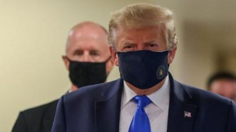 Donald Trump wears a mask for the first time in public