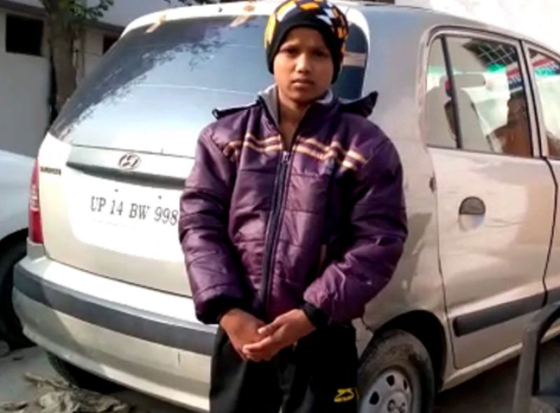 Homeless Boy sleeping on a footpath with a dog