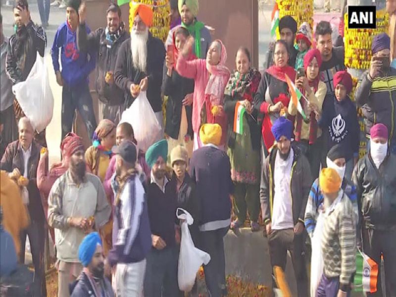 Locals in delhi shower flower petals on farmers